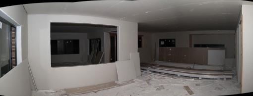 Plastered room - standing in the opposite corner in the family room.  Opening to the left is the rumpus room.  And straight ahead is the dining and kitchen.