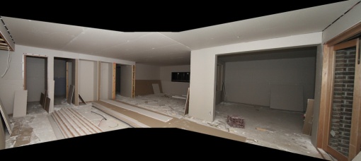 Plastered room - standing in the dining room.  Left is the kitchen, straight ahead is the family room and the doorway on the right is the rumpus room.